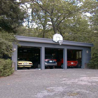 The garage is below and to the right of the house. It holds four cars and my workshop. Dave's two Alfas are visible plus Vi's Subaru. The Bimmer is in front of the red Alfa, since it hardly ever gets used when the weather's nice.
